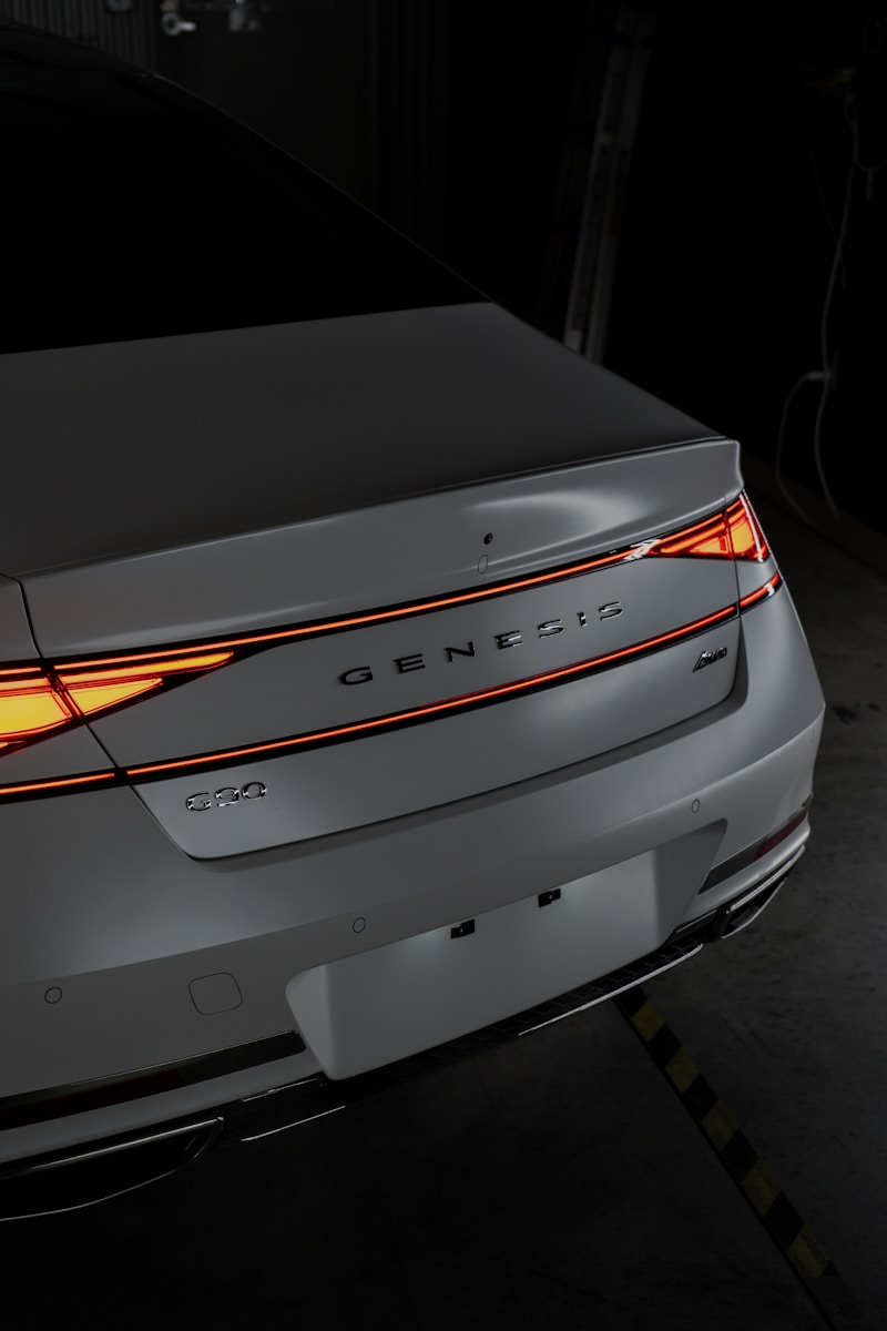 A car is shown with its tail lights on