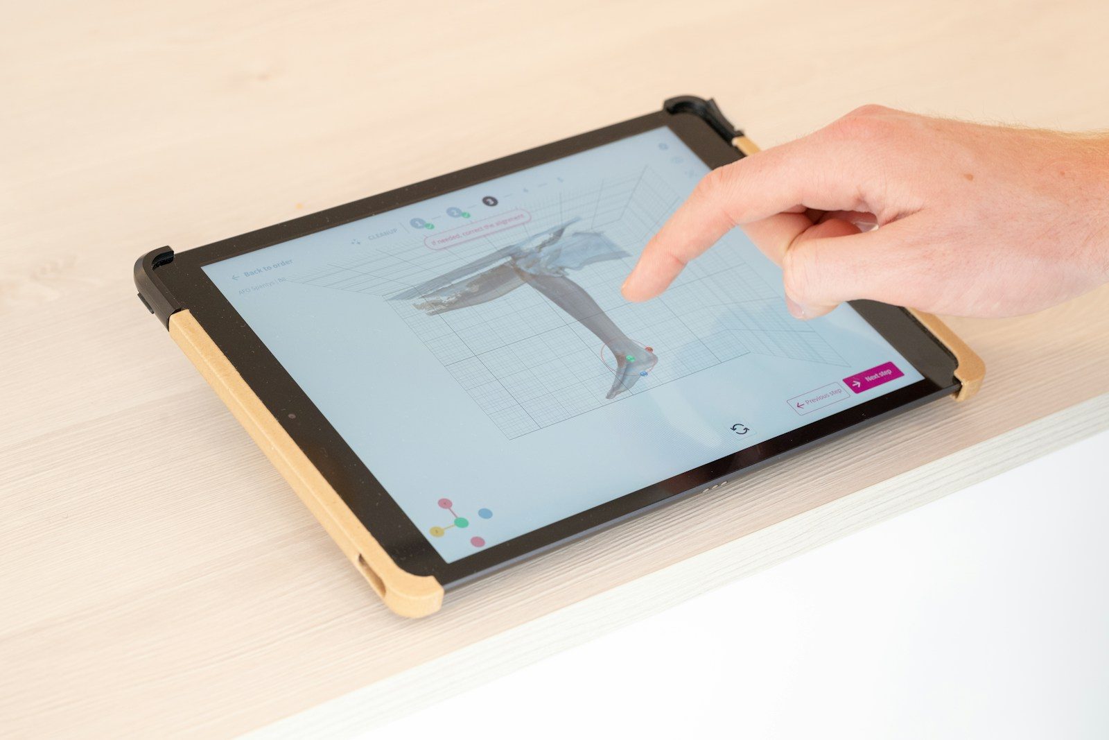 a person is pointing at a tablet screen